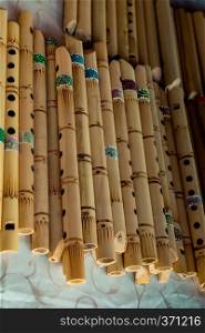 Dozens of handmade bamboo flutes in the view
