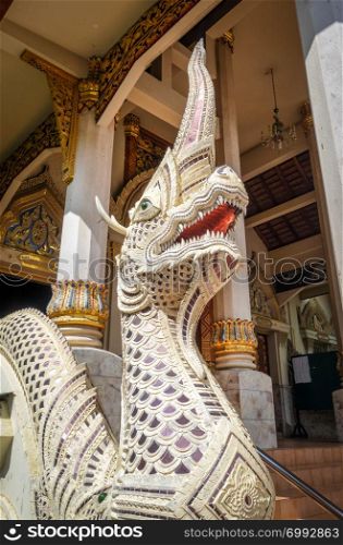Dragon statue in Wat Chomphu temple, Chiang Mai, Thailand. Statue in Wat Chomphu temple, Chiang Mai, Thailand