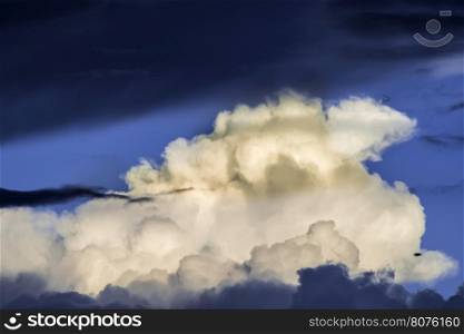 Dramatic clouds and deep blue sky. Sunset