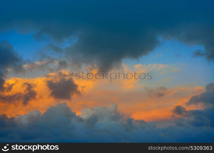 Dramatic clouds at sunset sky orange clouds