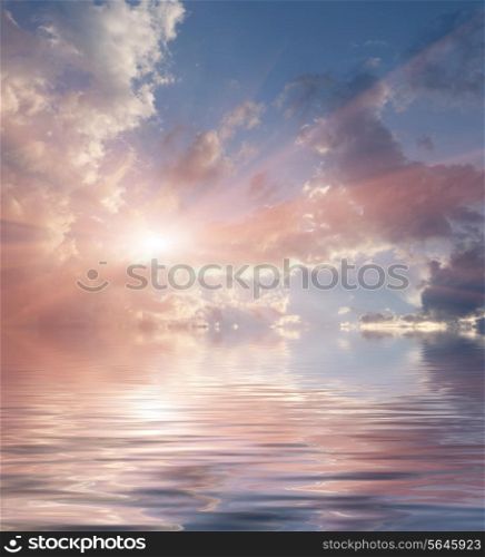 Dramatic colorful sky with clouds. Sunset over the water