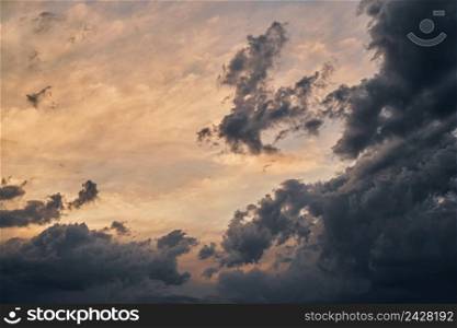Dramatic colorful twilight sky before a thunderstorm with wind clouds on a black sea beach
