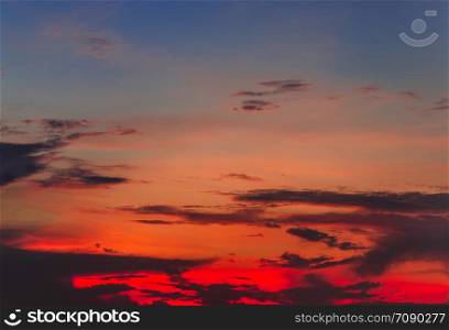 Dramatic Fiery red sunset and cloudy tropical sky as abstract background