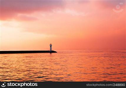 Dramatic golden sunset over Bosphorus strait with signal light house in Istanbul, Turkey