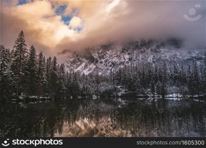 Dramatic landscape of lake in forest near mountains durring winter. Pond on the way to gruner see, Green Lake.. Dramatic landscape of lake in forest near mountains durring winter.