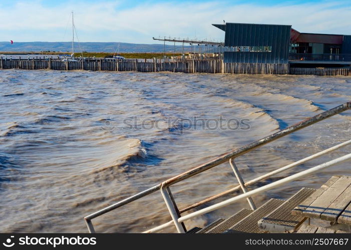 Dramatic landscape with stormy lake, restaurant by the side. Neusiedler See, Austria