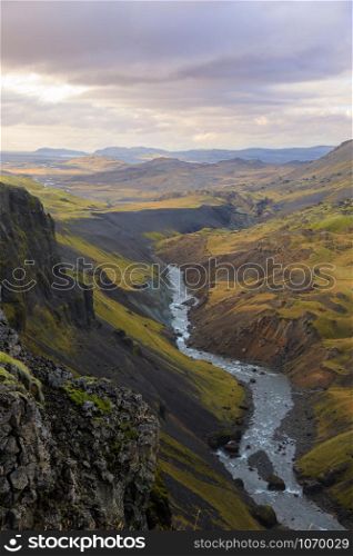 Dramatic overview of Haifoss waterfall, the fourth highest waterfall(122m) of the island, and colorful canyon situated near the volcano Hekla in southern Iceland.