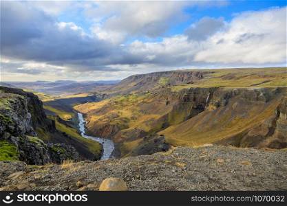 Dramatic overview of Haifoss waterfall, the fourth highest waterfall(122m) of the island, and colorful canyon situated near the volcano Hekla in southern Iceland.