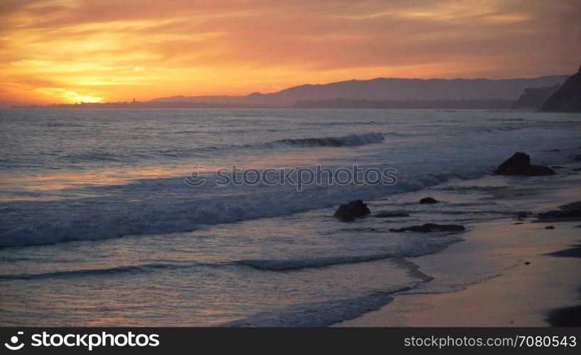 Dramatic pink and orange sunset at Mesa Beach