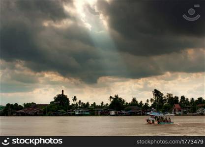 Dramatic rainstorm over ferryboat on Chao Phraya River, the major river in Thailand.