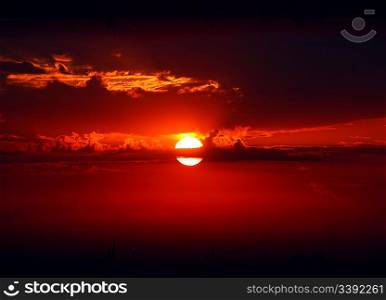 dramatic red sunrise on dark sky with clouds