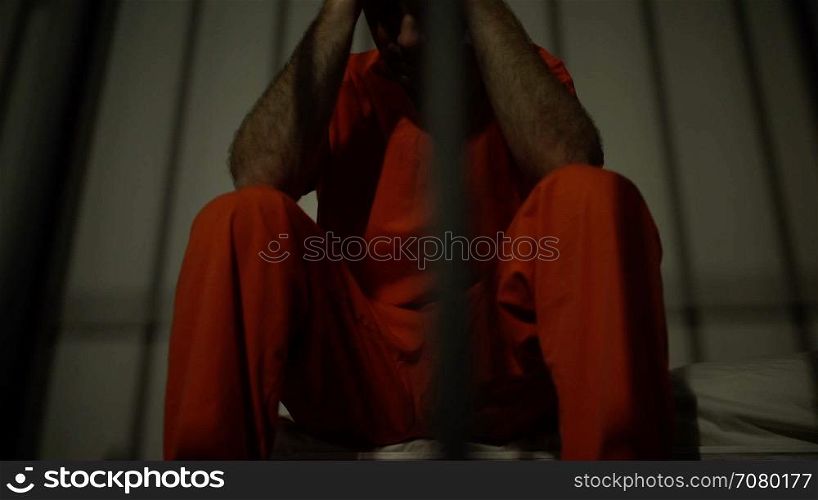 Dramatic scene of a depressed inmate in jail