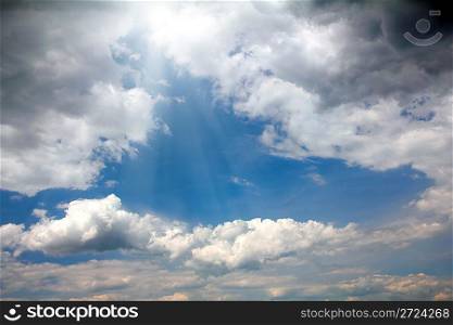 dramatic scene with clouds and blue sky behind