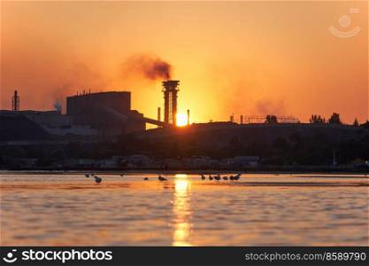 Dramatic Sea sunset over the Azovstal plant in Mariupol city