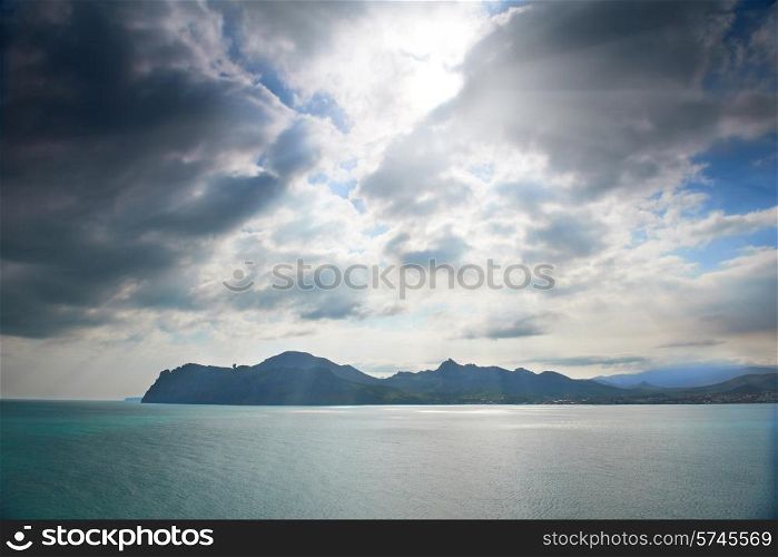 Dramatic sea with island and blue dark sky