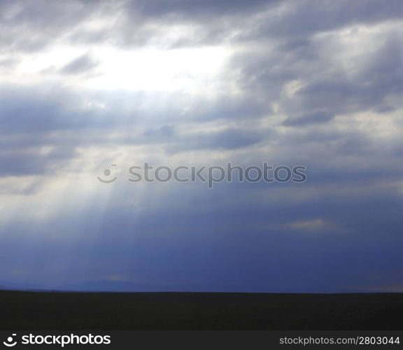 Dramatic sky and rays falling through the clouds