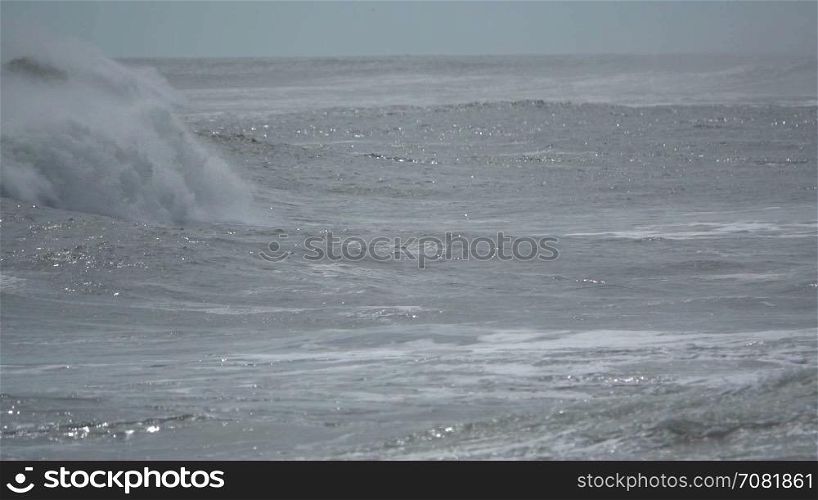 Dramatic slow mo waves rumble across frame