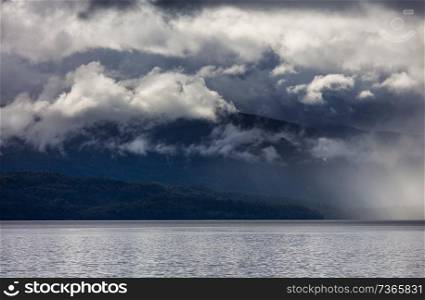 Dramatic storm clouds above oceanic coast in Chile