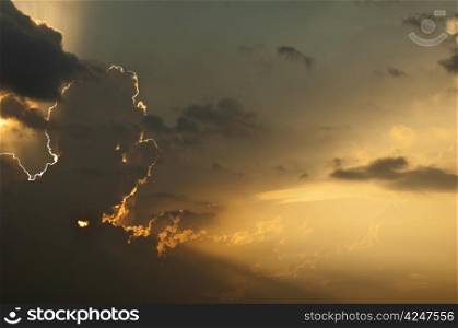 Dramatic sunburst through cumulus clouds in the evening