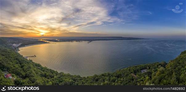 Dramatic sunset above the sea bay. Aerial drone view of sea and coastline of Varna, Bulgaria