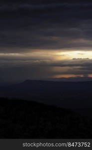 Dramatic sunset light illuminates distant downpours across the Shenandoah Valley and behind Massanutten Mountain.