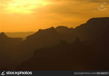 Dramatic sunset silhouettes of layers of Grand Canyon ridges. Location is along Desert View Drive in this famous, Arizona national park in America&rsquo;s Southwest.