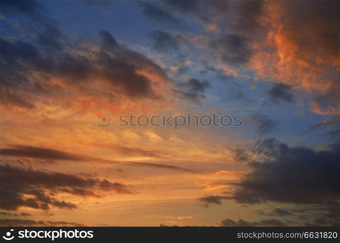 Dramatic sunset sky with orange and gray clouds