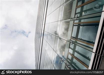 Dramatic view of skyscrapers against cloudy sky. View of the skyscraper from below