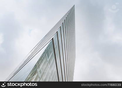 Dramatic view of skyscrapers against cloudy sky. View of the skyscraper from below