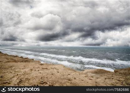 Dramatic weather over the sea with a rough coastal surface under a cloudy sky