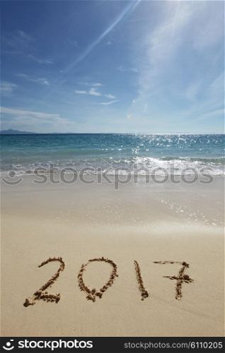 Drawing 2017 on the sand. Drawing 2017 on the sand of a tropical beach