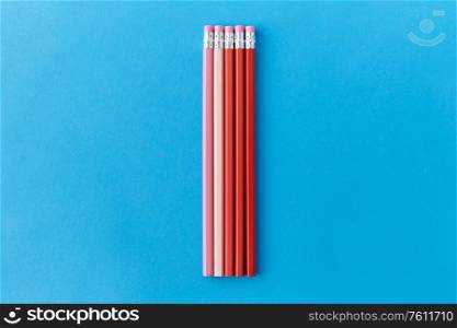 drawing, education and object concept - five lead pencils with eraser on tip on blue background. five lead pencils with eraser on tips