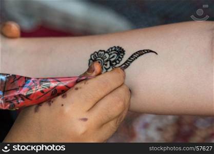 Drawing Floral Henna Tatoo on Female Arm