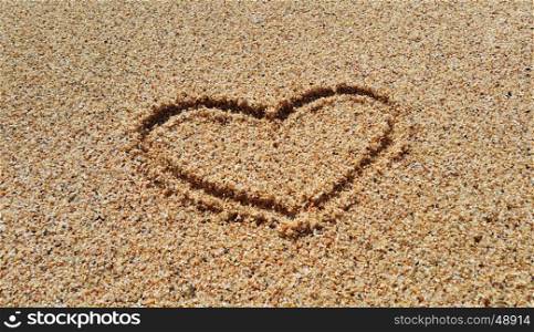 Drawing of abstract heart in the sand on beach