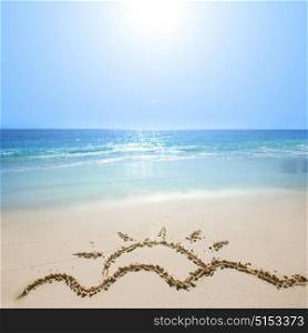 Drawing of sun on beach sand. Drawing of waves and hot summer sun on golden beach sand conceptual of a summer vacation on a tropical beach