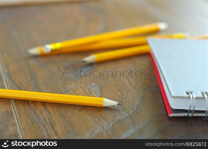 Drawing pencil with notebook on desk table working place. Idea memories reminder concept. Personal notepaper kit.