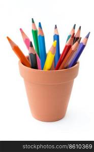 Drawing supplies  assorted color pencils in ceramic pot, isolated on white background  . Color pencils