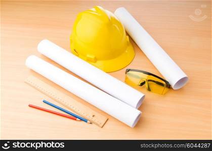 Drawings and hard hat on the desk