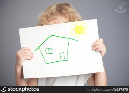 Drawn sun and house in baby hands. Spring concept