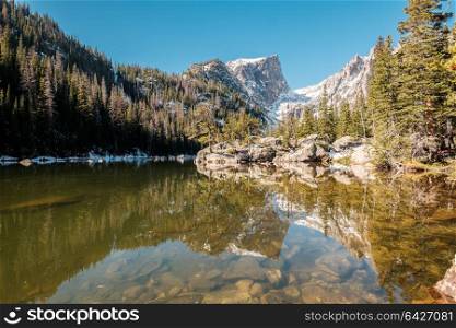 Dream Lake and reflection with mountains in snow around at autumn. Rocky Mountain National Park in Colorado, USA.