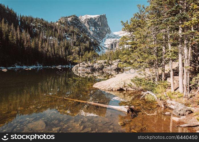 Dream Lake and reflection with mountains in snow around at autumn. Rocky Mountain National Park in Colorado, USA.