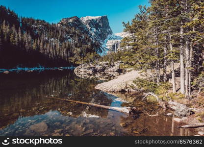 Dream Lake and reflection with mountains in snow around at autumn. Rocky Mountain National Park in Colorado, USA. 