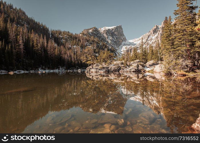 Dream Lake and reflection with mountains in snow around at autumn. Rocky Mountain National Park in Colorado, USA. 