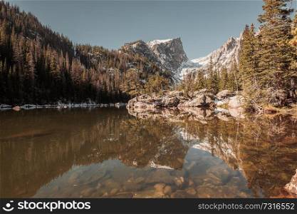Dream Lake and reflection with mountains in snow around at autumn. Rocky Mountain National Park in Colorado, USA. 
