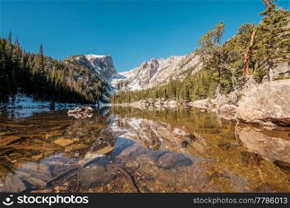 Dream Lake and reflection with mountains in snow around at autumn. Rocky Mountain National Park in Colorado, USA. 