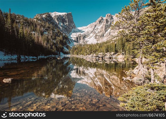 Dream Lake, Rocky Mountains, Colorado, USA. . Dream Lake and reflection with mountains in snow around at autumn. Rocky Mountain National Park in Colorado, USA.