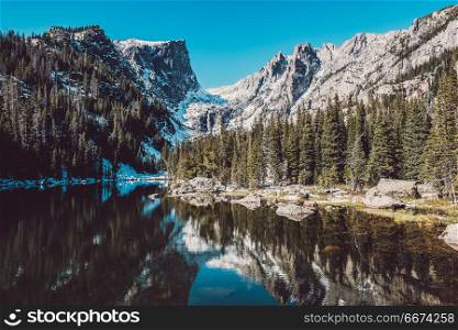 Dream Lake, Rocky Mountains, Colorado, USA. . Dream Lake and reflection with mountains in snow around at autumn. Rocky Mountain National Park in Colorado, USA.