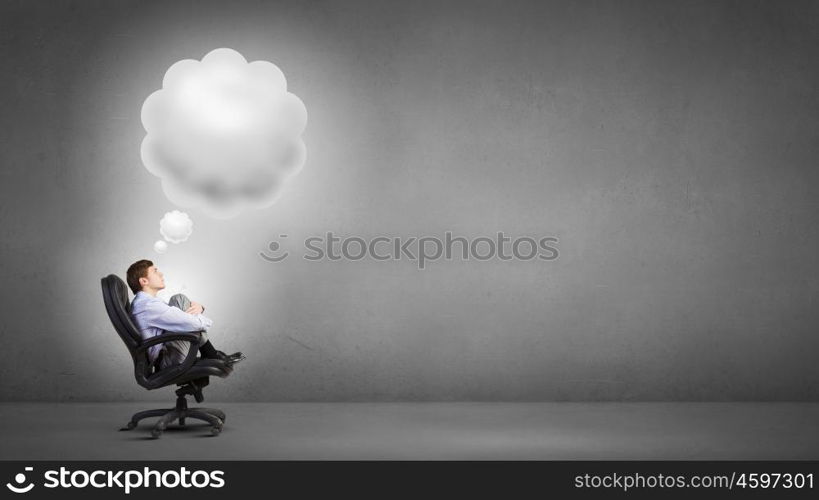 Dreaming businessman. Confident handsome businessman sitting in chair and dreaming