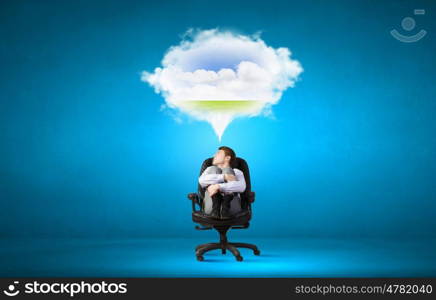 Dreaming businessman. Confident handsome businessman sitting in chair and dreaming