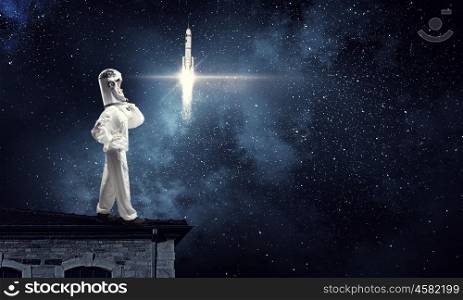 Dreaming to explore space. Young woman with carton box on head imagine she is astronaut